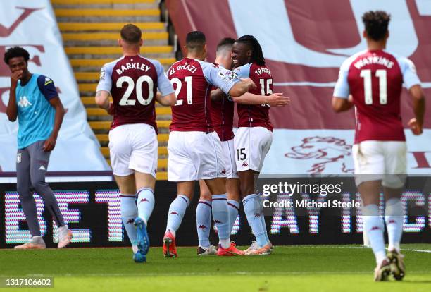 Bertrand Traore of Aston Villa celebrates with Anwar El Ghazi and John McGinn after scoring their team's first goal during the Premier League match...