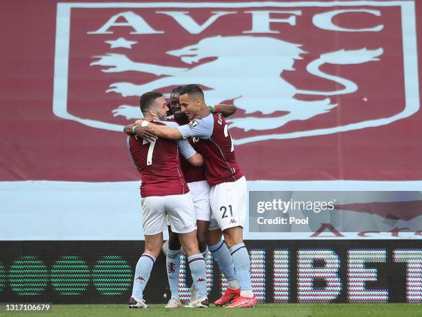 Bertrand Traore of Aston Villa celebrates with Anwar El Ghazi and John McGinn after scoring their team's first goal during the Premier League match...