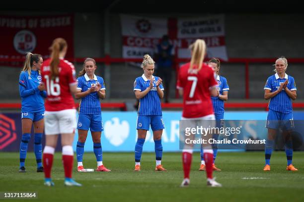 Players from both teams hold a minute’s applause in memory of Julie Chipchase during the Barclays FA Women's Super League match between Brighton &...