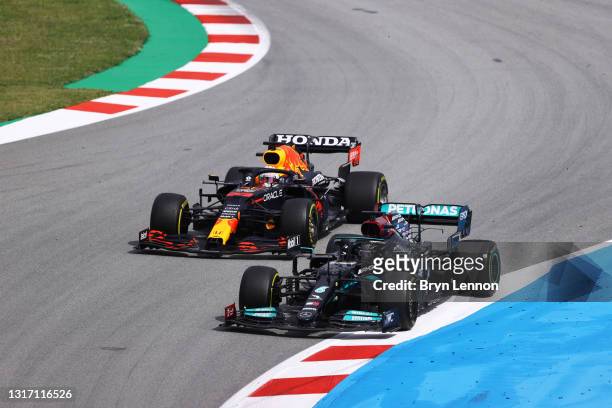 Lewis Hamilton of Great Britain driving the Mercedes AMG Petronas F1 Team Mercedes W12 leads Max Verstappen of the Netherlands driving the Red Bull...