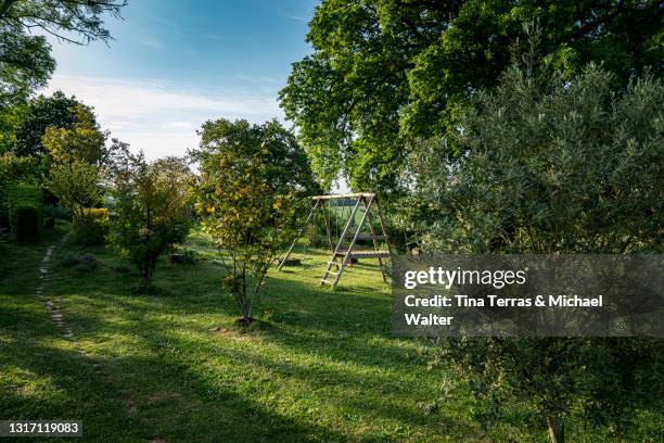 beautiful garden with flowers, lawn and children's toys in france. - フランス　公園 ストックフォトと画像