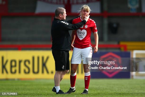 Dejected Gemma Evans of Bristol City is comforted by manager Matt Beard as she reacts after the final whistle after Bristol City are relegated during...