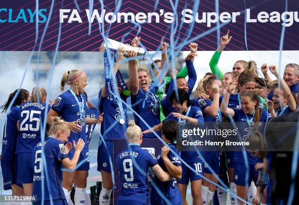 Magdalena Eriksson and Millie Bright of Chelsea lift the Barclays FA Women's Super League Trophy as their team mates celebrate after the Barclays FA...