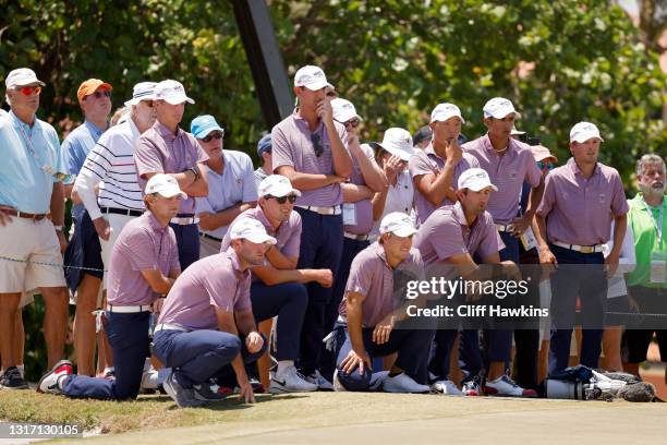 Members of Team USA look on from the 18th green during Sunday foursomes matches on Day Two of The Walker Cup at Seminole Golf Club on May 09, 2021 in...