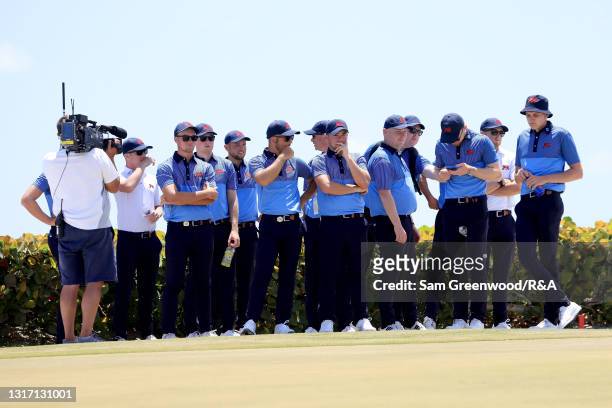 Members of Team Great Britain and Ireland look on from the 18th green during Sunday foursomes matches on Day Two of The Walker Cup at Seminole Golf...