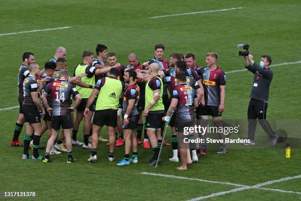 The Harlequins players form a huddle after the Gallagher Premiership Rugby match between Harlequins and Wasps at Twickenham Stoop on May 09, 2021 in...