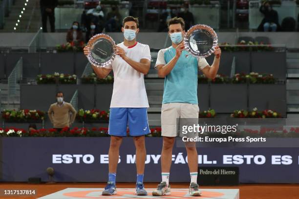 Marcel Granollers of Spain and Horacio Zeballos of Argentina pose for photo with the trophy after winning their Men's Doubles Final match against...