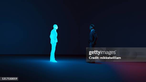 man meets digital avatar of himself made with a hologram - hologram person stock pictures, royalty-free photos & images