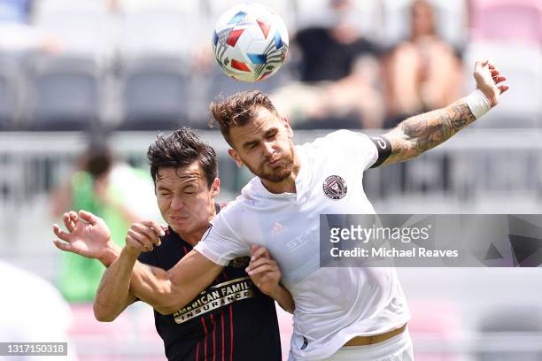 Erick Torres of Atlanta United and Leandro Gonzalez of Inter Miami CF battle for a header during the second half at DRV PNK Stadium on May 09, 2021...