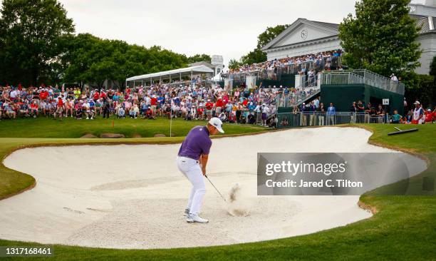 Luke List of the United States plays a shot from a bunker on the 18th hole during the final round of the 2021 Wells Fargo Championship at Quail...