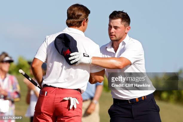 Pierceson Coody of Team USA and Alex Fitzpatrick of Team Great Britain and Ireland shake hands on the 17th green after Coody won their match during...