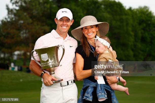 Rory McIlroy of Northern Ireland celebrates with the trophy alongside his wife Erica and daughter Poppy after winning during the final round of the...
