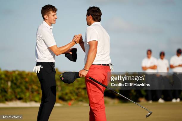 Barclay Brown of Team Great Britain and Ireland and Quade Cummins of Team USA shake hands on the 18th green after their match finished in a tie...