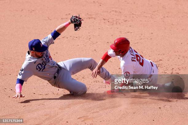 Gavin Lux of the Los Angeles Dodgers is unable to handle the throw as David Fletcher of the Los Angeles Angels steals second base during the eighth...
