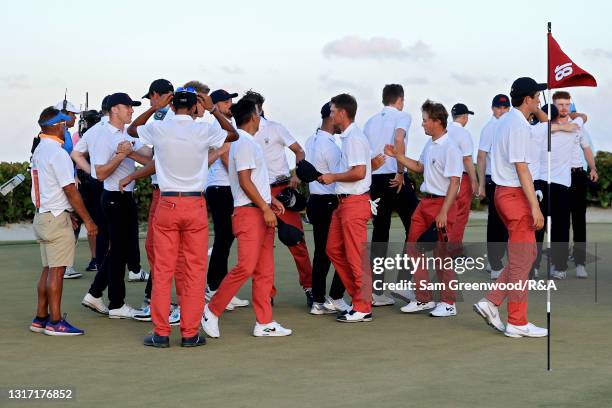 Members of Team USA and Team Great Britain and Ireland shake hands on the 18th green after Team USA beat Team Great Britain and Ireland 14-12 during...