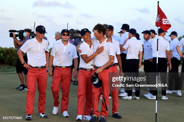 John Pak and Tyler Strafaci of Team USA celebrate during Sunday singles matches on Day Two of The Walker Cup at Seminole Golf Club on May 09, 2021 in...