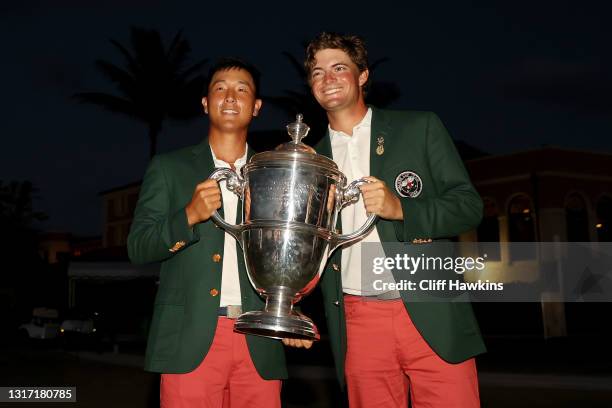 John Pak and Tyler Strafaci of Team USA pose with the trophy after defeating Team Great Britain and Ireland 14-12 during Sunday singles matches on...