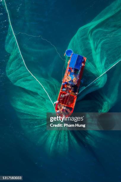 fishing boat on the sea - vietnamese fishing net stock pictures, royalty-free photos & images