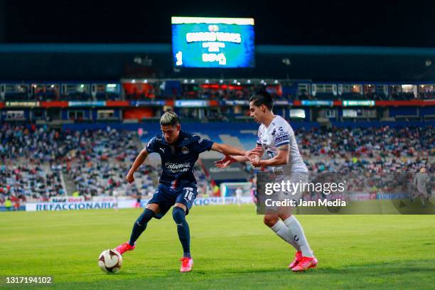 Jose Macias of Chivas fights for the ball with Erick Aguirre of Pachuca during the playoff match between Pachuca and Chivas as part of the Torneo...