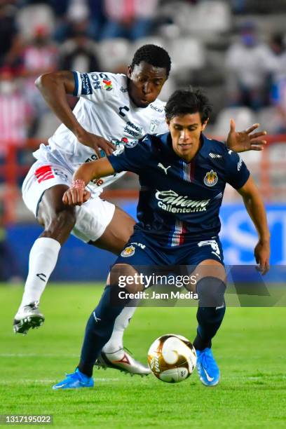 Oscar Murillo of Pachuca fights for the ball with Jose Macias of Chivas during the playoff match between Pachuca and Chivas as part of the Torneo...