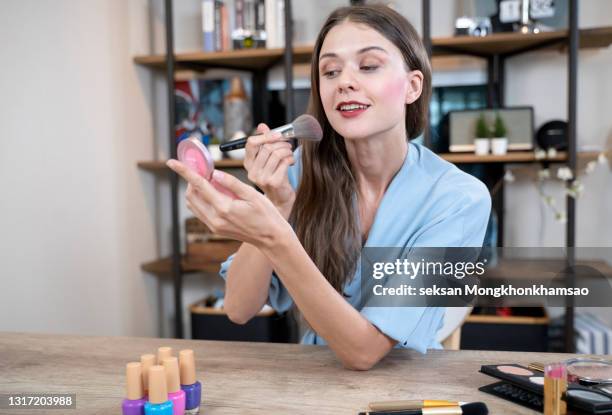routine actions for every woman concept. portrait of pretty charming sexy confident concentrated carefree calm peaceful employee doing make up at workstation casual clothes - makeup mirror stock pictures, royalty-free photos & images