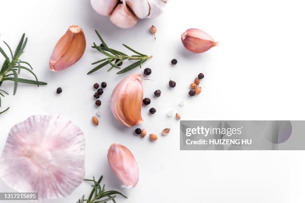 garlic and herbs on white background - garlic clove stock-fotos und bilder