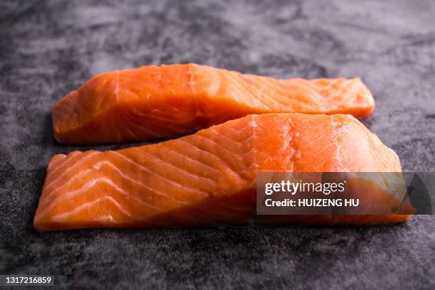 fresh salmon fillet on black background - laxfilé bildbanksfoton och bilder