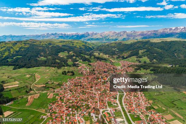 wide drone shot of koprivshtitsa, bulgaria,  stara planina and cloudy blue sky (bulgarian: копривщица и стара планина) - bulgaria history stock pictures, royalty-free photos & images