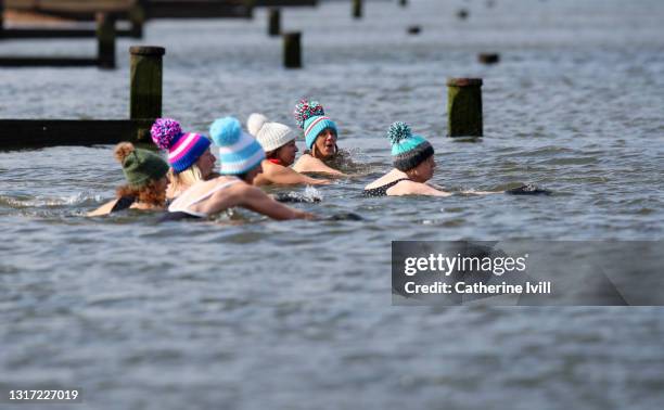 group of confident women swim in open water - menopossibilities fotografías e imágenes de stock