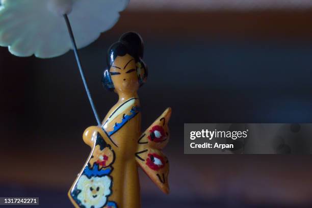Macro close up shot of a wooden Kimono Girl with umbrella Minifigure Series Japanese geisha dolls culture and traditional of asia with copy paste space
