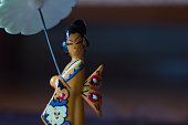 Macro close up shot of a wooden Kimono Girl with umbrella Minifigure Series Japanese geisha dolls culture and traditional of asia with copy paste space