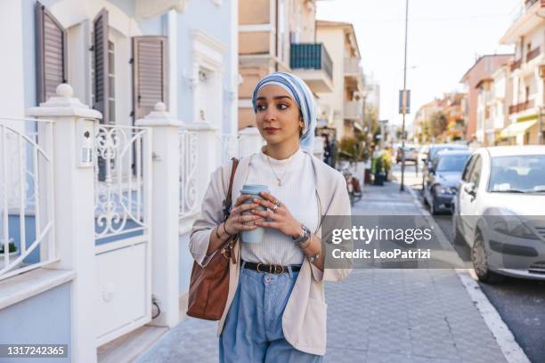 young woman walking to the office - north african people stock pictures, royalty-free photos & images