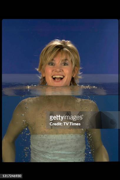Television presenter Anthea Turner photographed floating in a swimming pool, circa 1998.