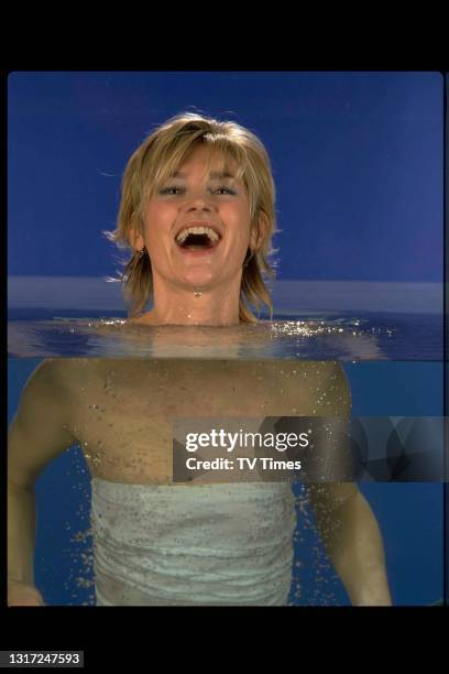 Television presenter Anthea Turner photographed floating in a swimming pool, circa 1998.