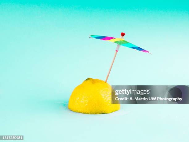 tropical beach concept made of lemon and sun umbrella. - cocktail umbrella foto e immagini stock