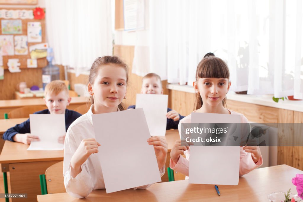 Students Using Paper Portrait Of Students Showing Paper In Classroom High-Res Stock Photo ...