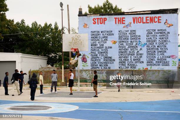 Mural illustrating the violence of the gangs, realized in a black district of Philadelphia, within the "Mural Art Program" which began in 1984. It's...