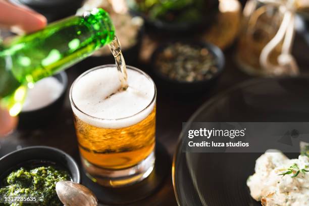 pouring beer into a glass - lager stock pictures, royalty-free photos & images