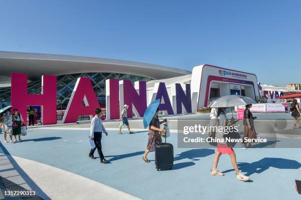 People walk out of Hainan International Convention and Exhibition Center as the First China International Consumer Products Expo closes on May 10,...