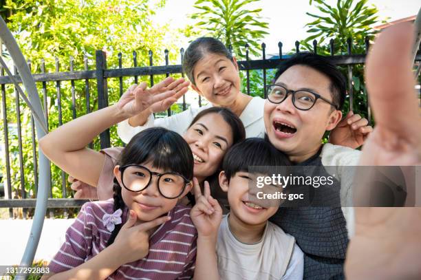 happy multi generation asian family taking selfie together on swing - family five people stock pictures, royalty-free photos & images