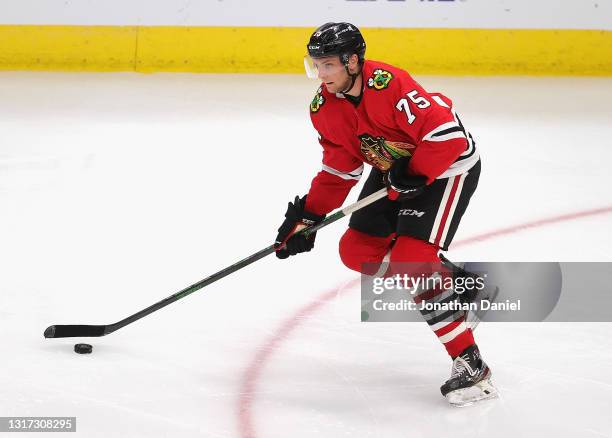 Alec Regula of the Chicago Blackhawks looks to pass against the Dallas Stars at the United Center on May 09, 2021 in Chicago, Illinois. The...