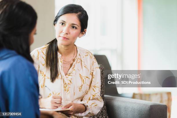 caring counselor listening to female patient - doctor listener imagens e fotografias de stock