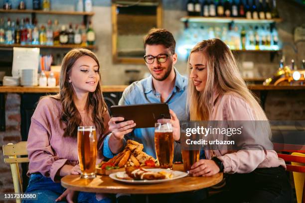 having good time in pub - pub food stock pictures, royalty-free photos & images