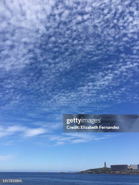 beautiful view of the torre de hercules from riazor, a coruna, galicia, spain - cirrocúmulo fotografías e imágenes de stock