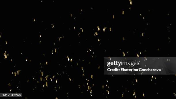 new year's shiny holiday background with falling gold confetti on black isolated background for overlay. - confetti gold ストックフォトと画像