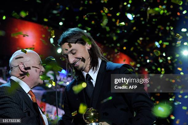 Milan soccer player Zlatan Ibrahimovic of Sweden receives the Golden Ball award from Lars-Aake Lagrell, President of the Swedish Football...