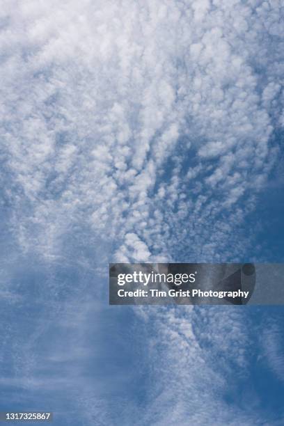 white clouds in a blue sky - altocumulus stock pictures, royalty-free photos & images