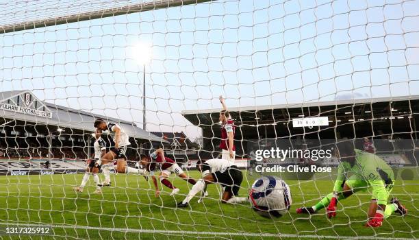 Ashley Westwood of Burnley scores their side's first goal past Tosin Adarabioyo and Alphonse Areola of Fulham during the Premier League match between...