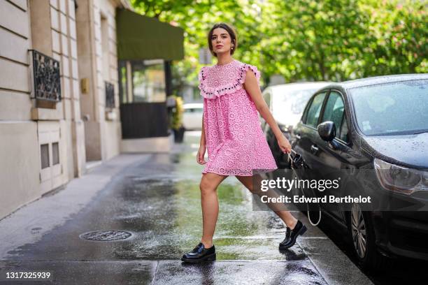 Ketevan Giorgadze @katie.one wears a pink babydoll sleeveless mini dress with embroidery "broderie anglaise" from Manoush, a black leather pearl bag...