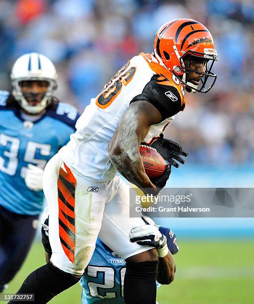 Donald Lee of the Cincinnati Bengals makes a catch against Jordan Babineaux of the Tennessee Titans during play at LP Field on November 6, 2011 in...